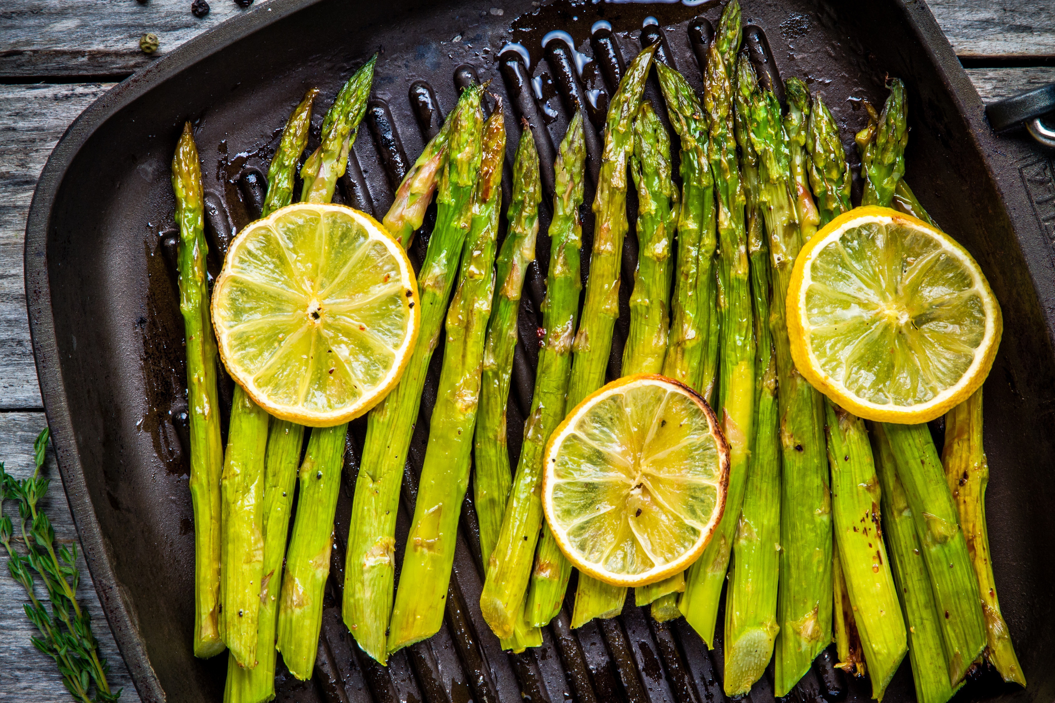 grilled organic asparagus with lemon in a frying pan