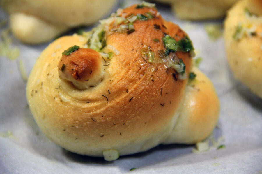 A garlic knot on parchment paper