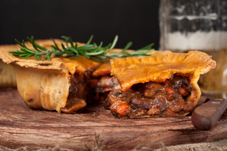 meat pie on wooden table closeup with copy space, rustic style