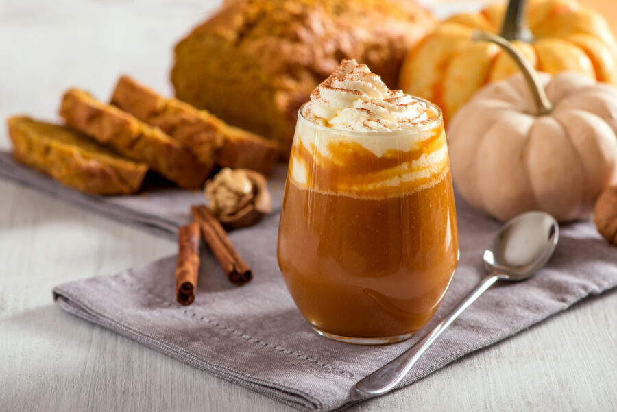 Pumpkin spice latte, hot coffee drink with pumpkins and pumpkin cake bread