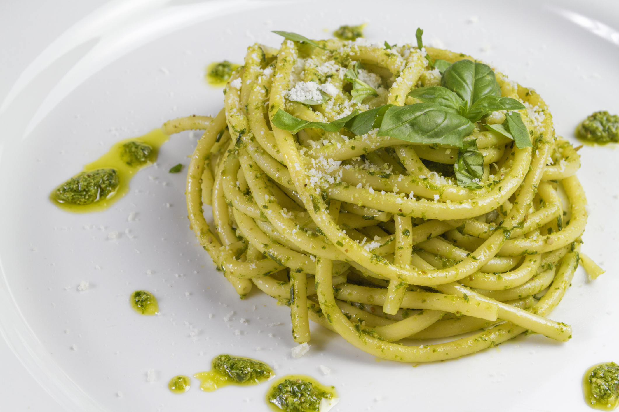 Spaghetti pasta Bucatini with pesto sauce and parmesan from wild garlic in white dish