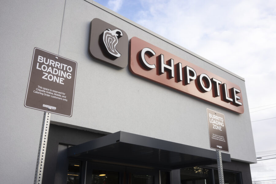 The Burrito Loading Zone parking signs are seen at the entrance to a Chipotle Mexican Grill restaurant 