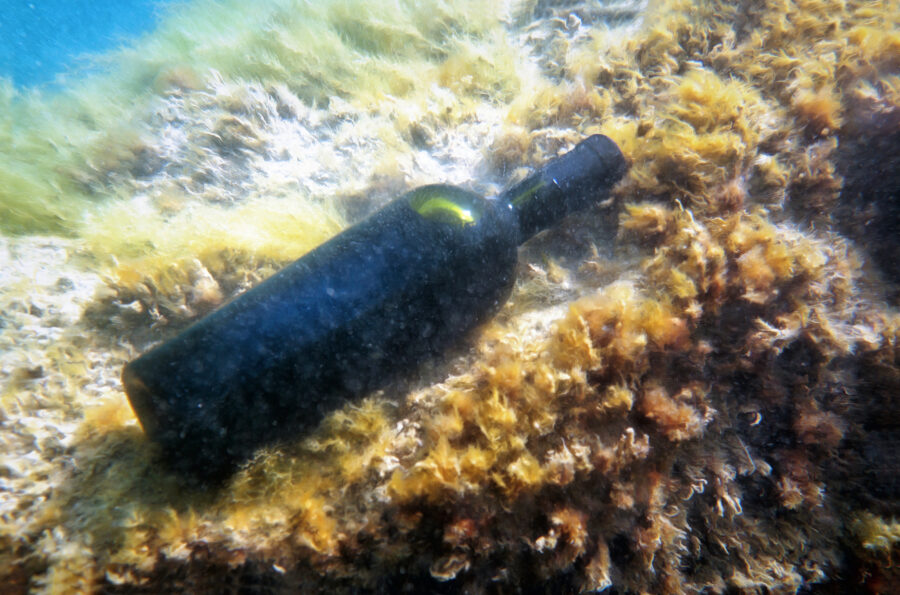 Sealed bottle of wine under water