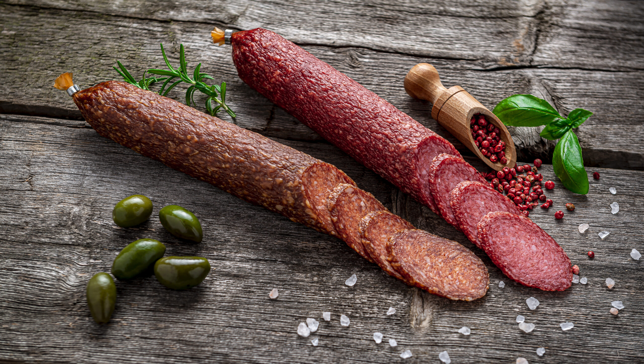 Best quality italian salami on old wooden table. Salami. Dried organic salami sausage or spanish chorizo