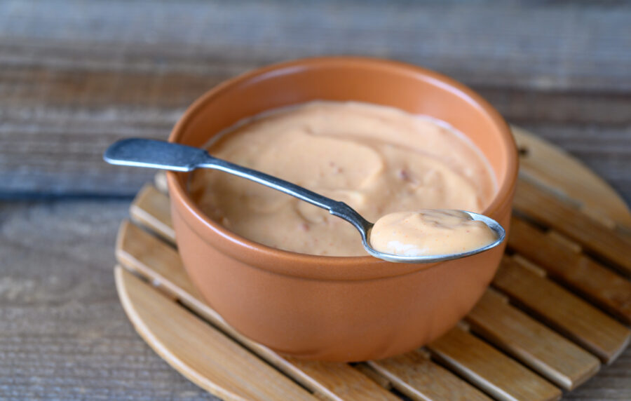 Bowl of Thousand Island dressing on wooden table