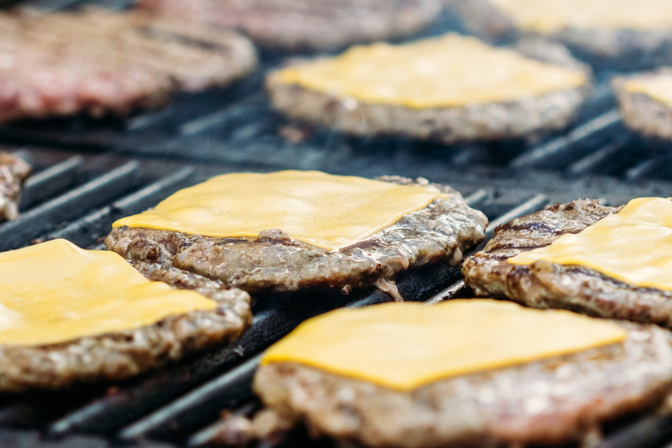 Burger cutlet with cheese close-up grilled in a diner