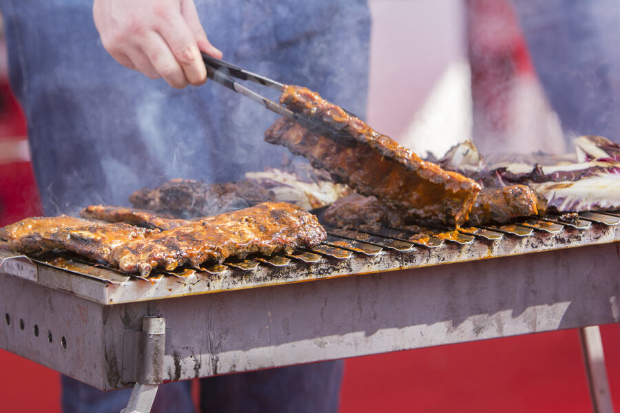 Chef bbq grilled pork ribs on smoke