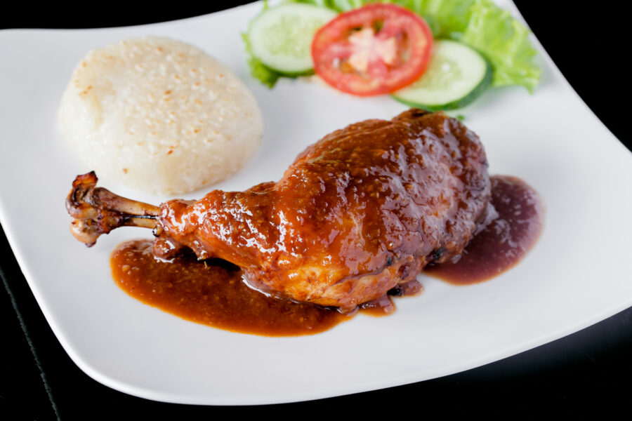 chicken fried with honey and rice on white dish