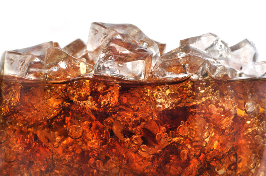 Detail macro image of a carbonated soda with crushed ice. carbonation bubbles rising to the top.