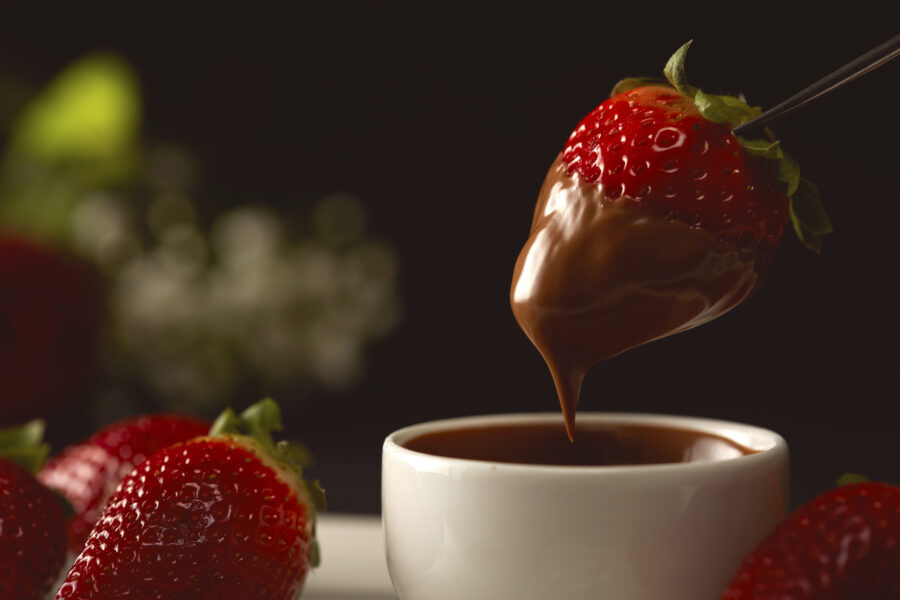 strawberries served with hot dark chocolate sauce