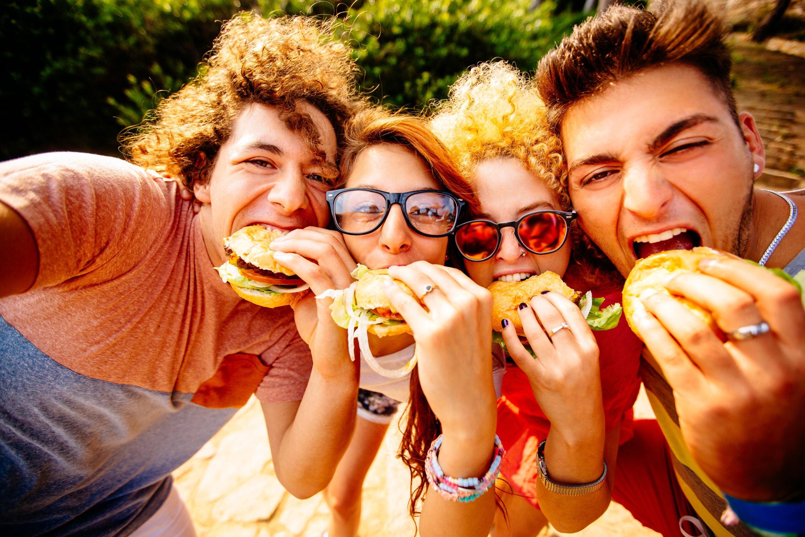 group of friends taking selfies with their hamburgers for lunch