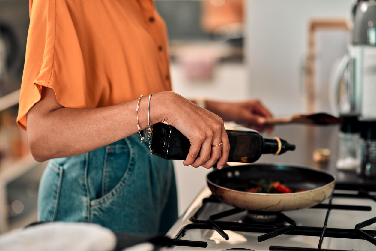 Cropped shot of a young woman preparing a healthy meal at home