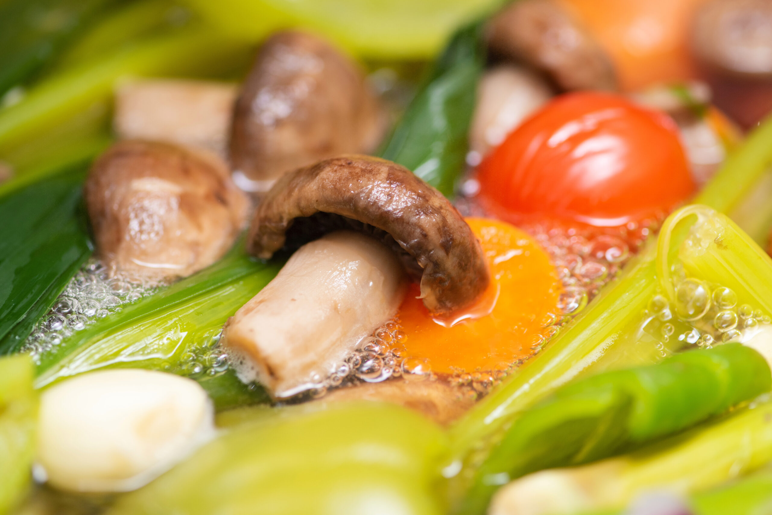 Vegetables simmering in a pot.