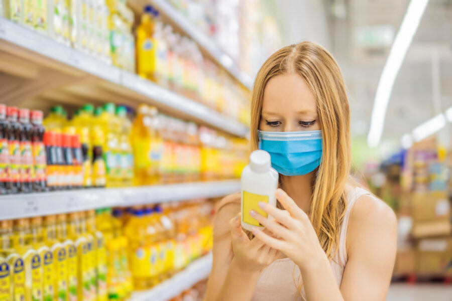 masked woman buying dressing