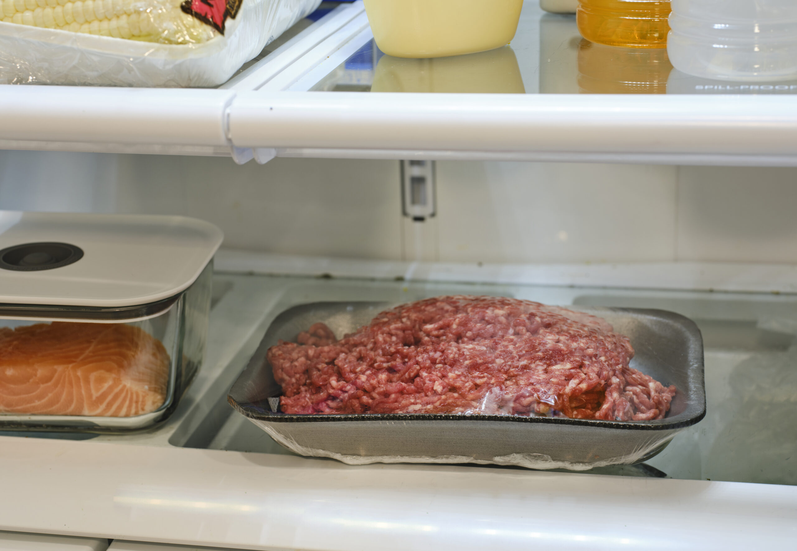 The inside of a refrigerator, with food stored in separate containers for safety.