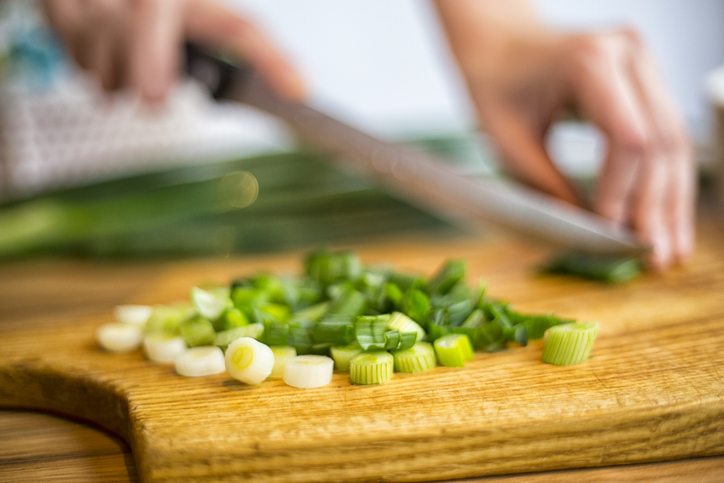 Cutting of spring onions for salad