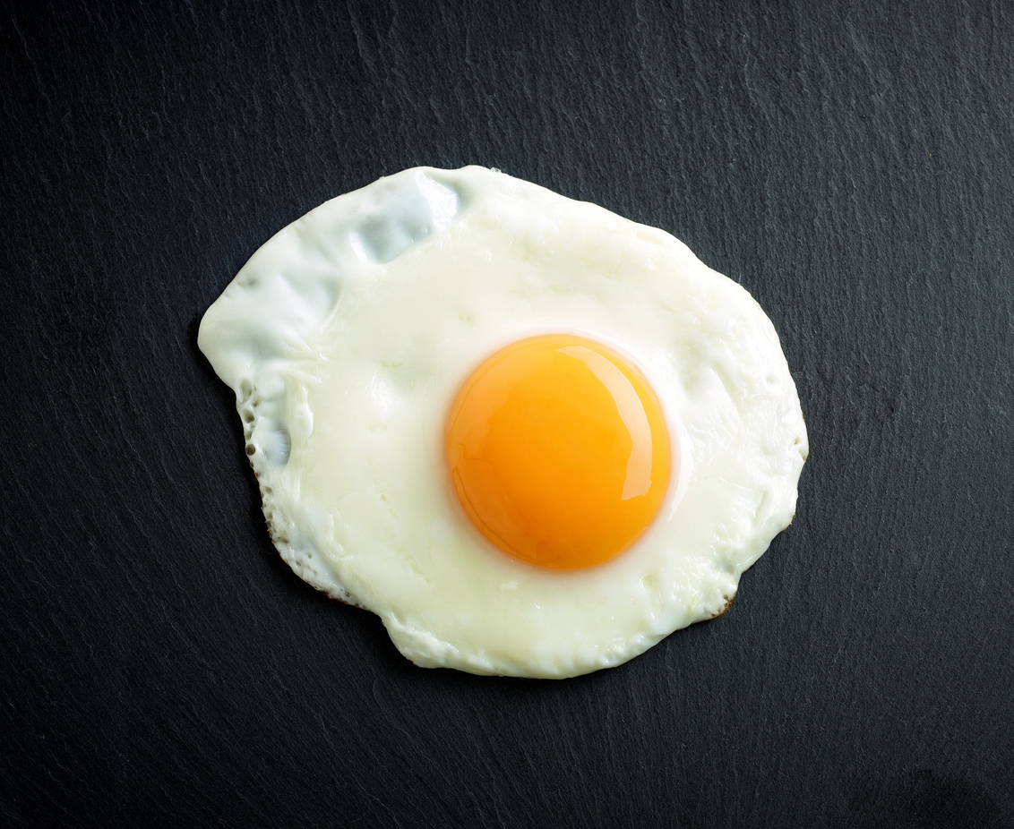 fried egg on black stone background