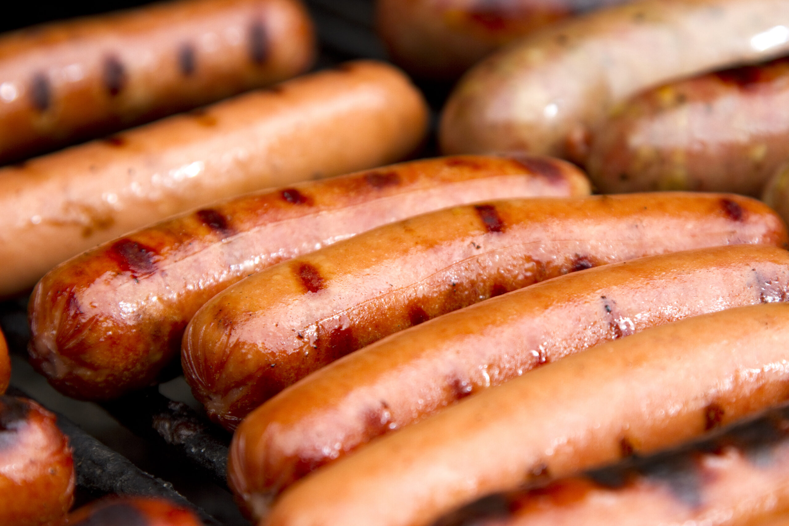 Juicy hot dogs on the grill.