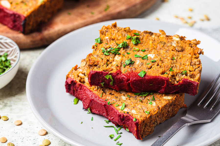 Lentil vegan meatloaf slices on a gray plate, close-up. 