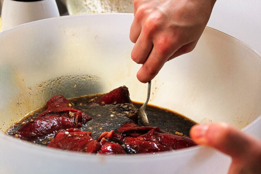 Mixing a batch of meat marinading for jerky.