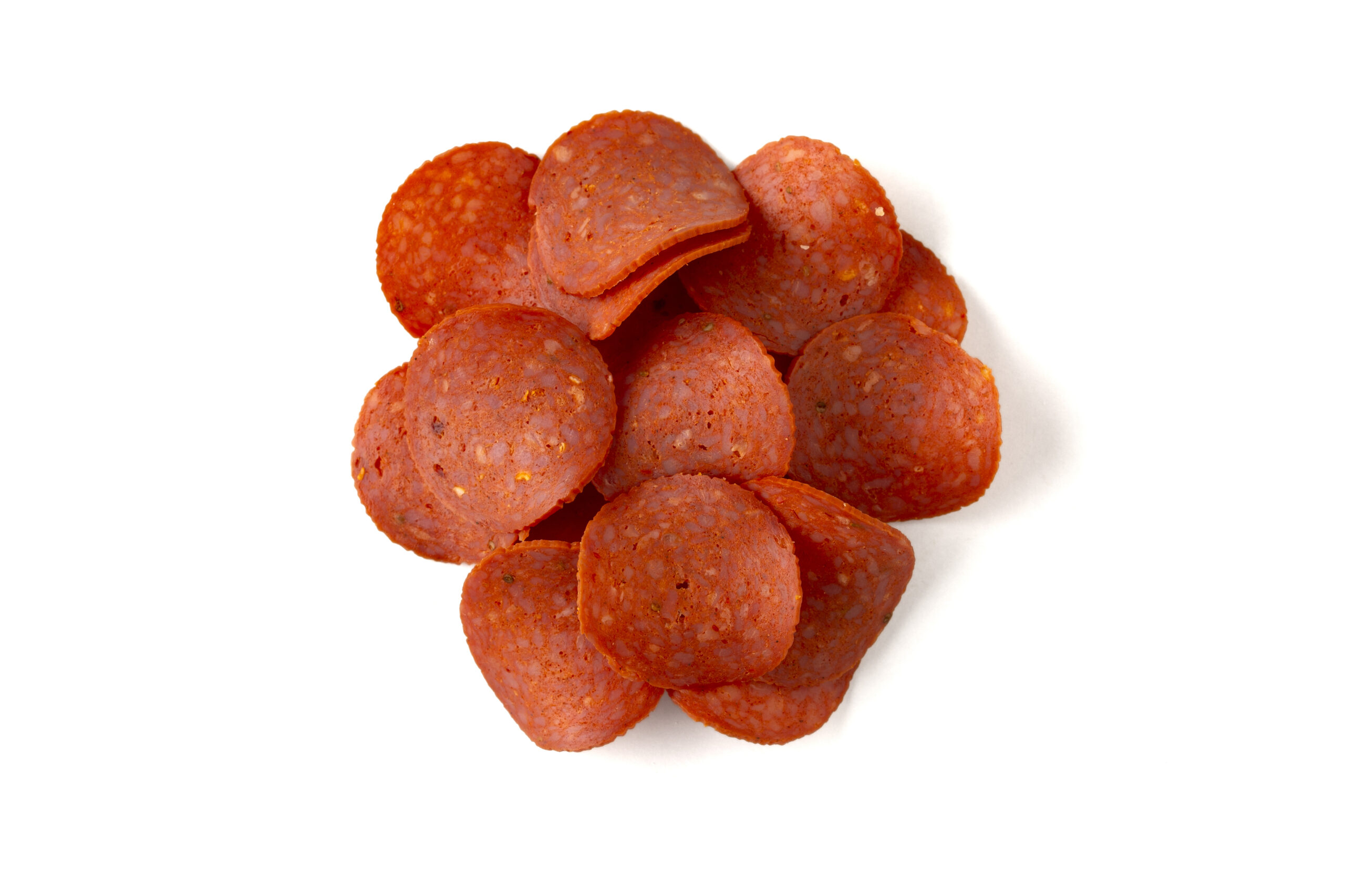 Pile of turkey pepperoni isolated on white background with clipping path.