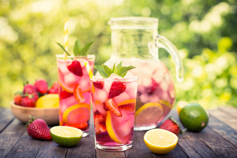 Pink lemonade with lemon, lime and strawberries