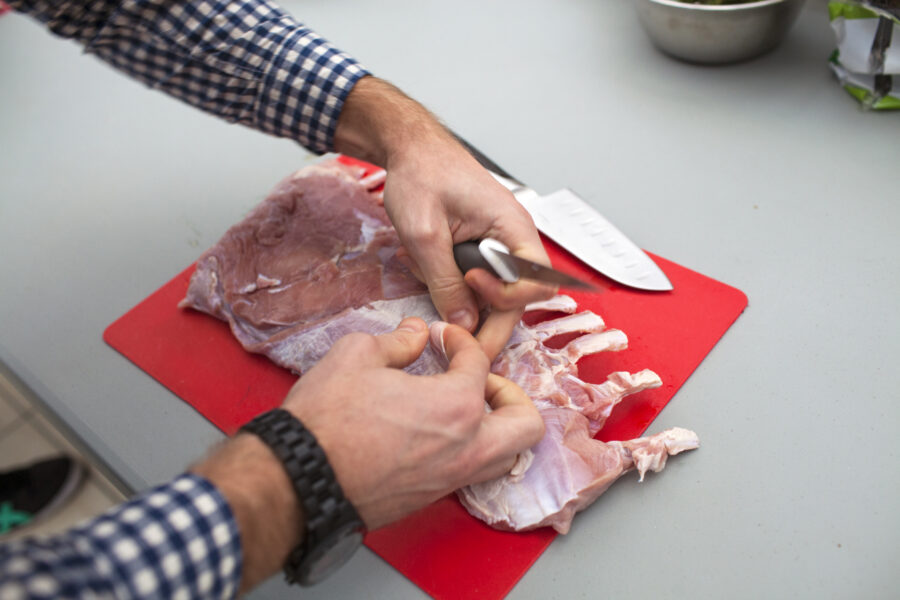 Preparing ribs in red cutting board