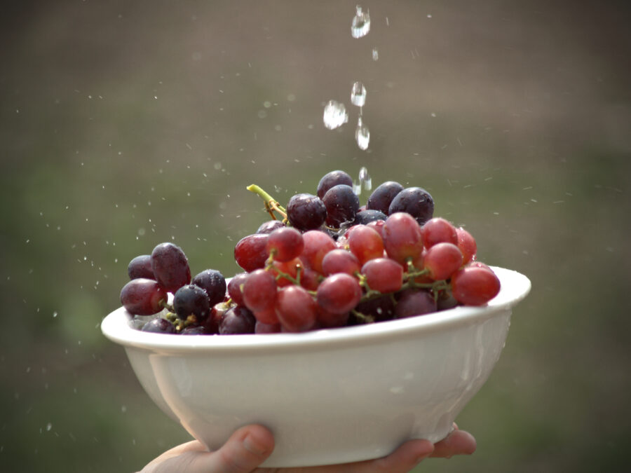 Rinsing Grapes in white bowl