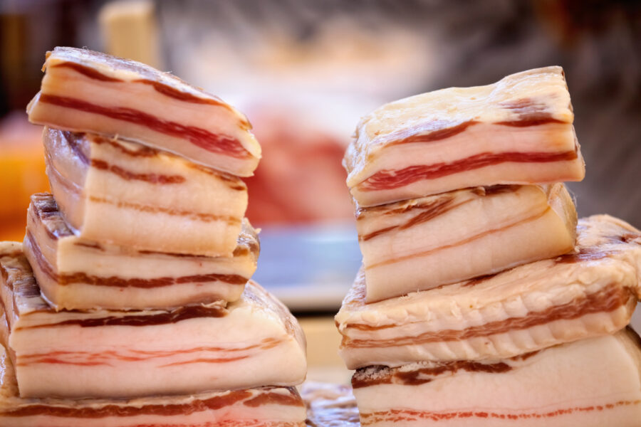 Stacks of pork belly Pancetta for sale 