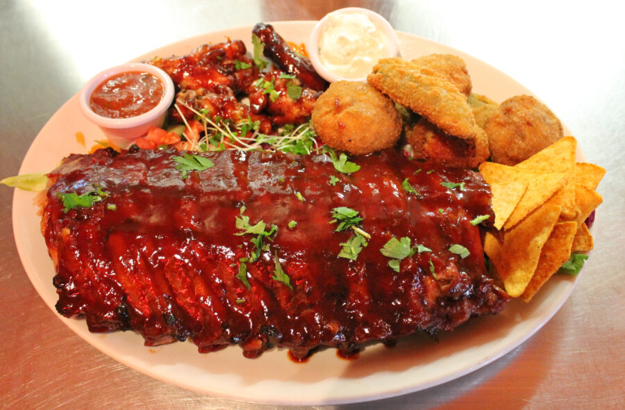 Tex mex BBQ ribs and wings platter with nachos