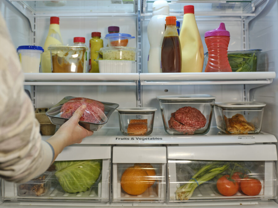 The inside of a refrigerator, with food stored in separate containers for safety.