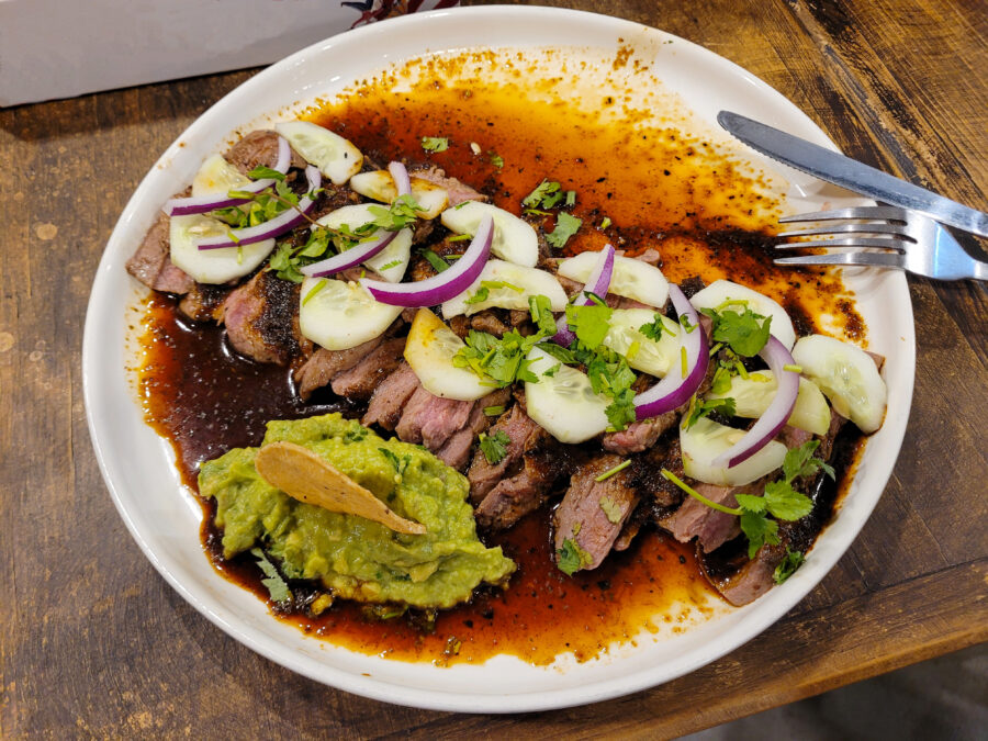 Traditional Mexican Aguachile dish with beef, avocado, and onions