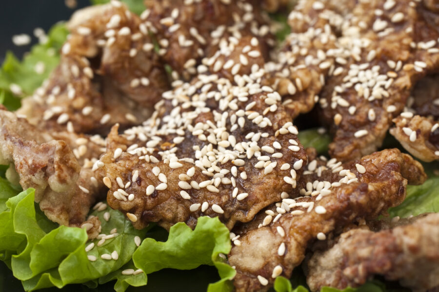 Vietnamese fried chicken with sesame seeds and lettuce