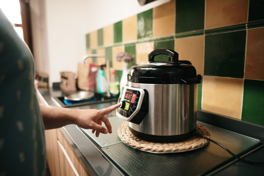 A hand programming an automatic pot