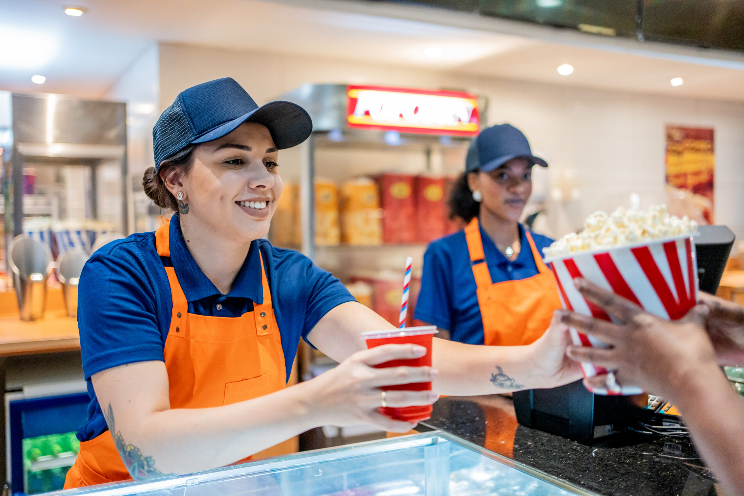 Attendant delivering popcorn and soda