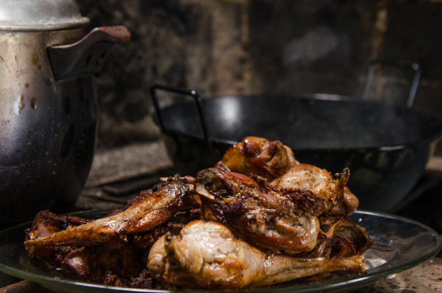 Frying rabbit meat over hot coals.