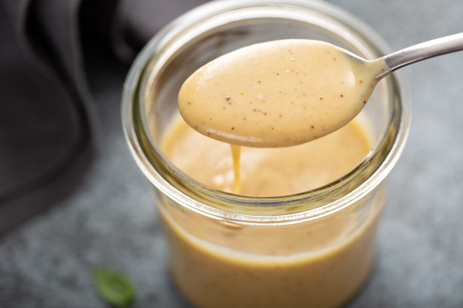 creamy honey mustard sauce in a glass jar