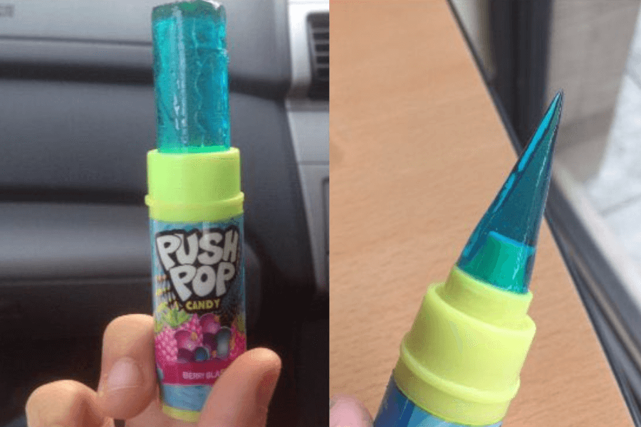 Two images of a blue Push Pop candy in the Berry Blast flavor. The left image shows the cylindrical lollipop fully extended from its neon green and blue container. The right image features the same candy sharpened into a pointed, spike-like shape.