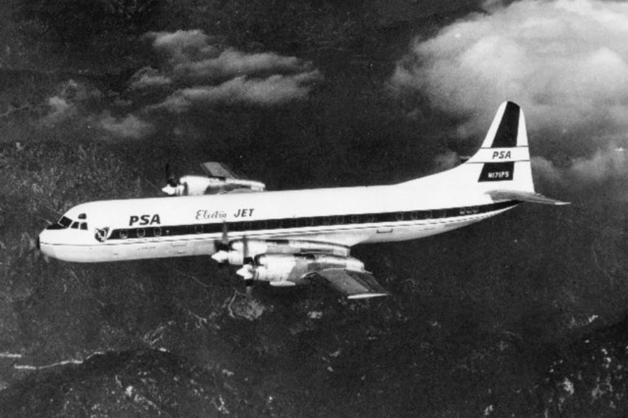 Black-and-white photo of a PSA (Pacific Southwest Airlines) Electra Jet aircraft in flight above mountainous terrain. The plane has "PSA" and "Electra JET" markings on the fuselage, and its registration number, N171PS, is visible on the tail.