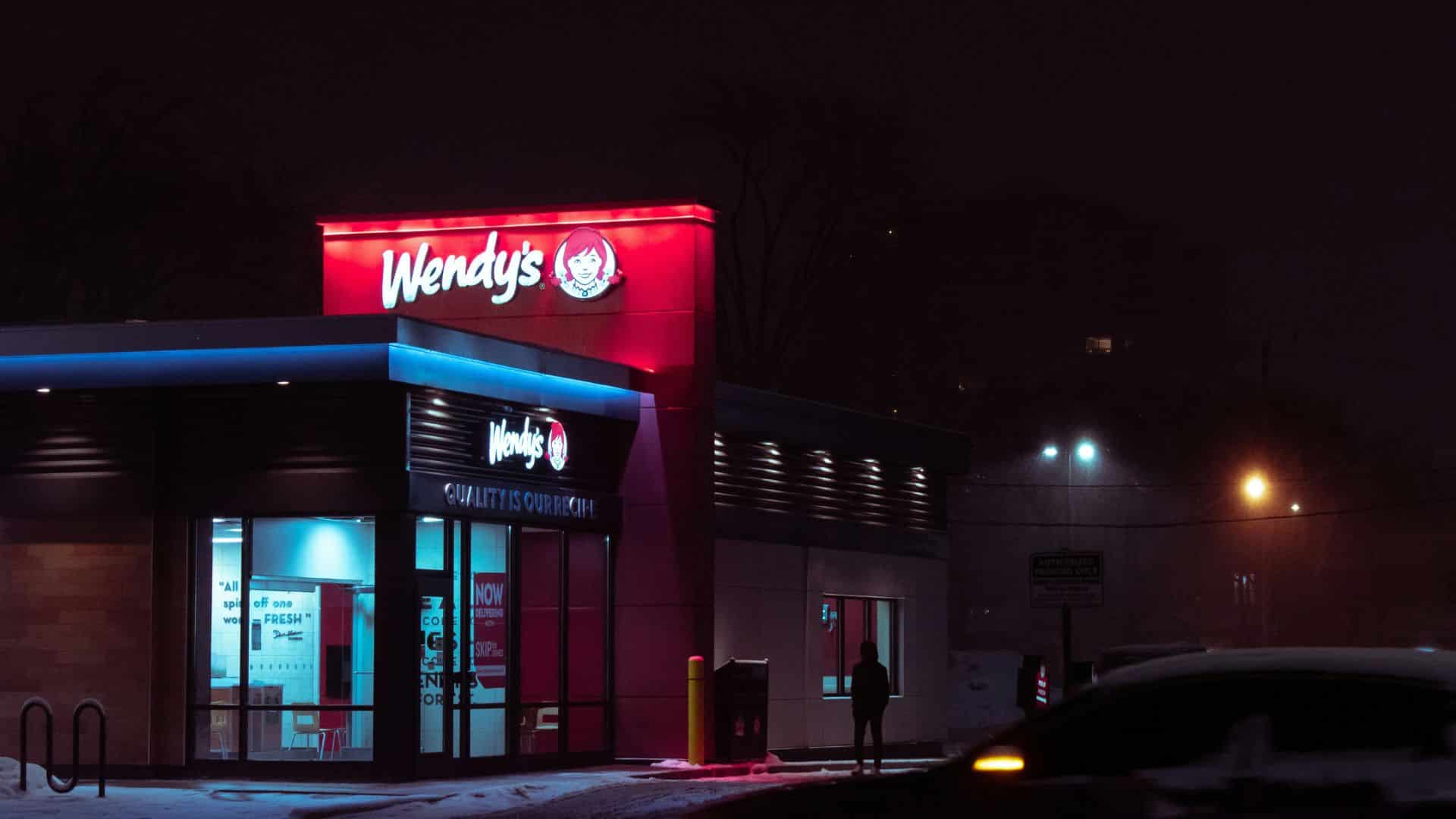 Red and white Wendy’s building lit up at night