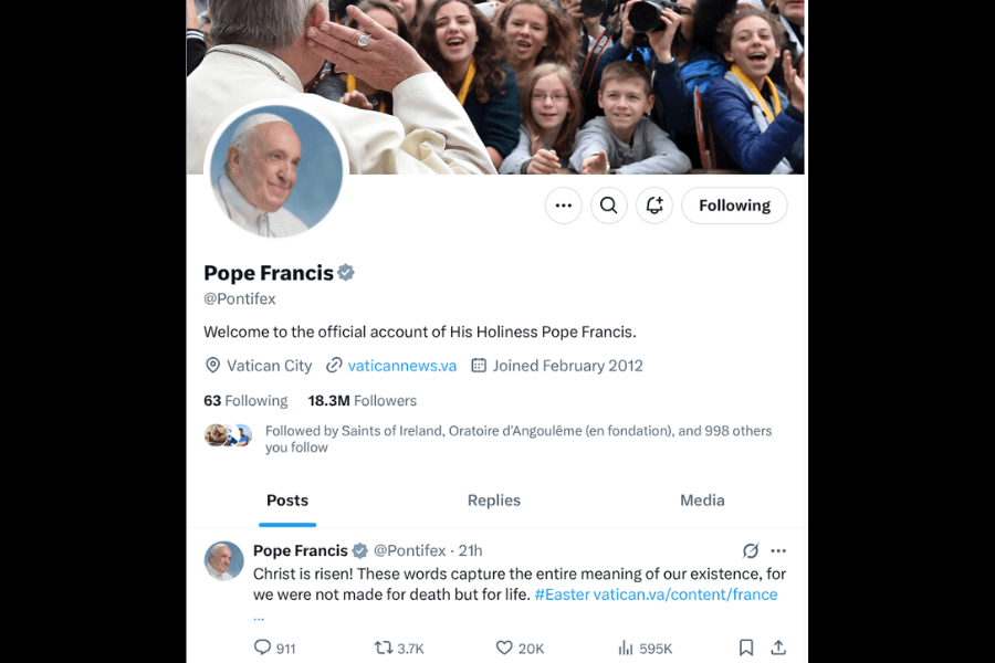 Screenshot of the official Twitter profile of Pope Francis (@Pontifex), showing a header photo of him greeting enthusiastic children, a profile image of the Pope smiling, and a recent tweet proclaiming “Christ is risen!” with Easter-related hashtags and a link to Vatican content.
