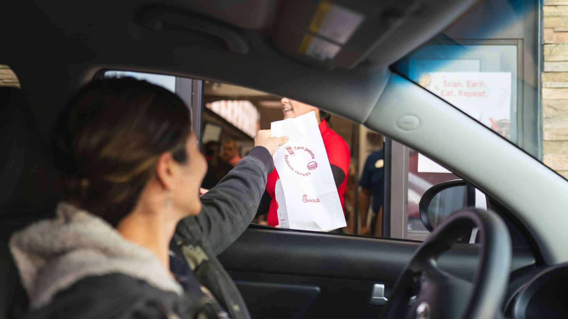Woman inside a vehicle at a drive-thru window