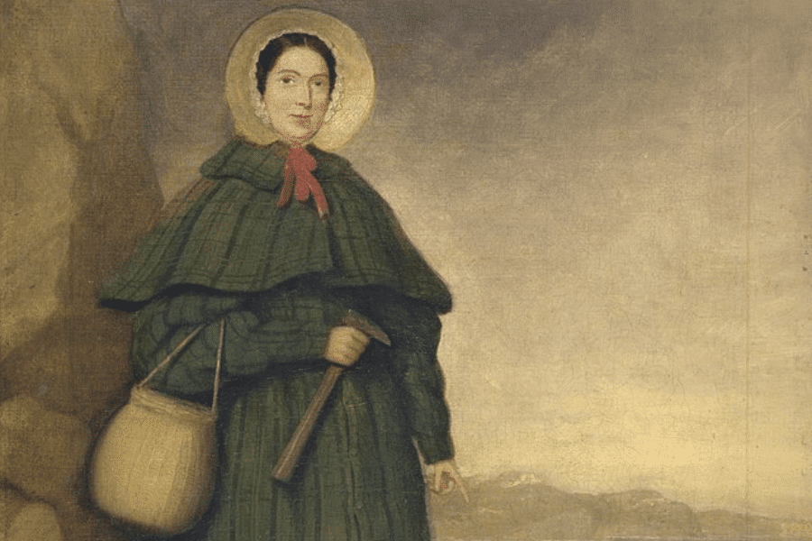 A historical painting of a woman in a green plaid dress and bonnet, standing outdoors with a hammer in one hand and a basket hanging from her arm. She wears a red ribbon at her neck and has a composed expression as she gestures toward the rocky landscape. The muted background features distant hills under a hazy sky.