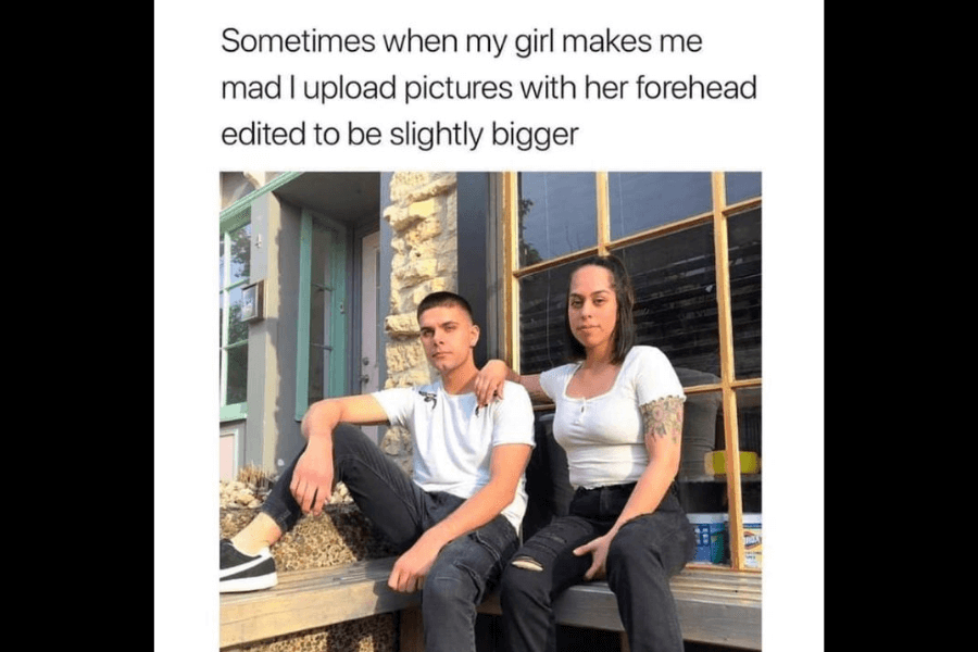 This image shows a man and woman seated outside on a wooden platform, with text above them humorously stating, "Sometimes when my girl makes me mad I upload pictures with her forehead edited to be slightly bigger." The image emphasizes the playful caption, suggesting a lighthearted and mischievous dynamic between the two.