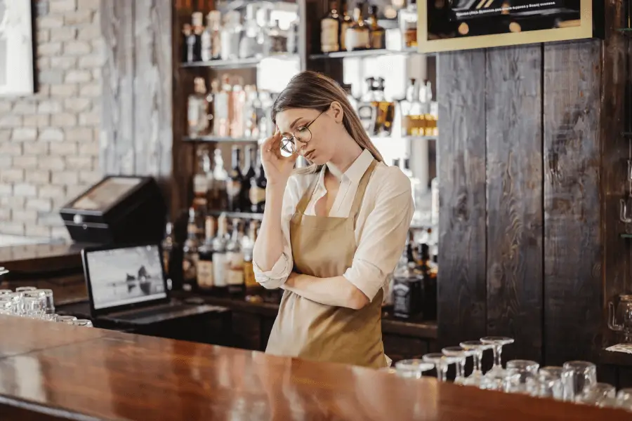 young and upset blonde white bartender