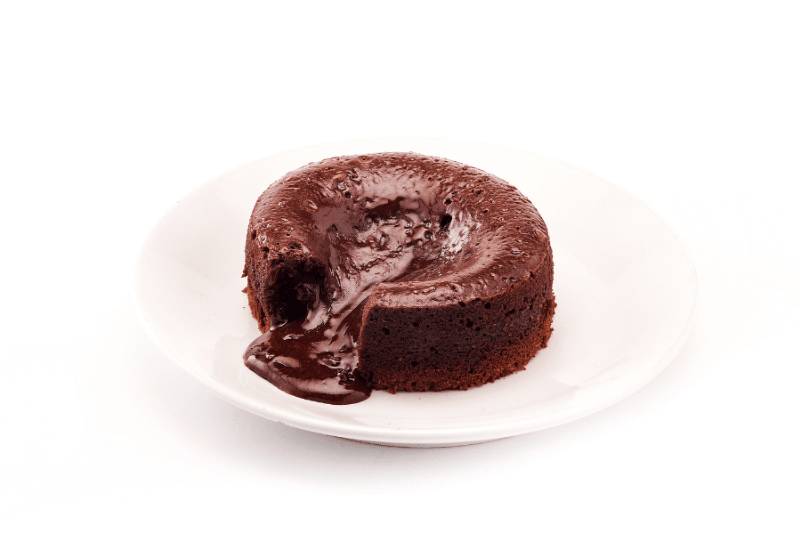 This image shows a chocolate lava cake on a white plate. The rich molten chocolate is oozing out from the center, creating an indulgent and appetizing presentation. The background is clean and white, highlighting the dessert.