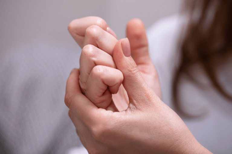 woman grabbing her hands