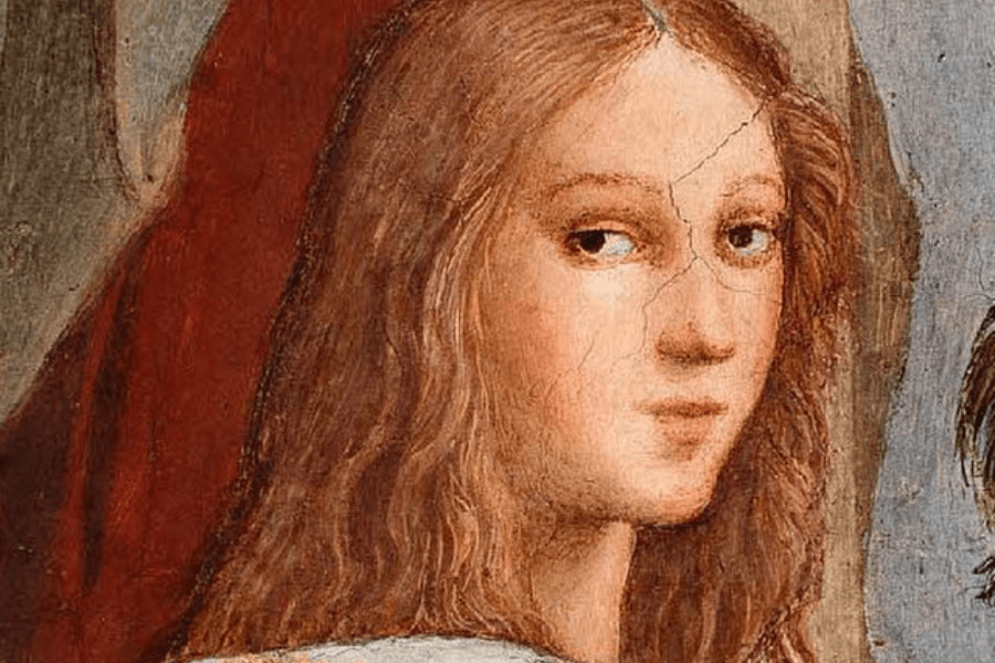 A close-up of a Renaissance fresco featuring a young woman with long, wavy auburn hair and a serene expression. Her gaze is directed slightly to the side, and the painting shows visible cracks, indicating its age. The background includes muted colors, with a glimpse of red fabric behind her.