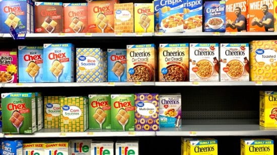 Stacked grocery store shelves with various labeled products at different heights