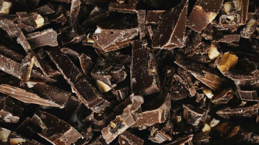 Sliced pieces of dark chocolate stacked on a surface